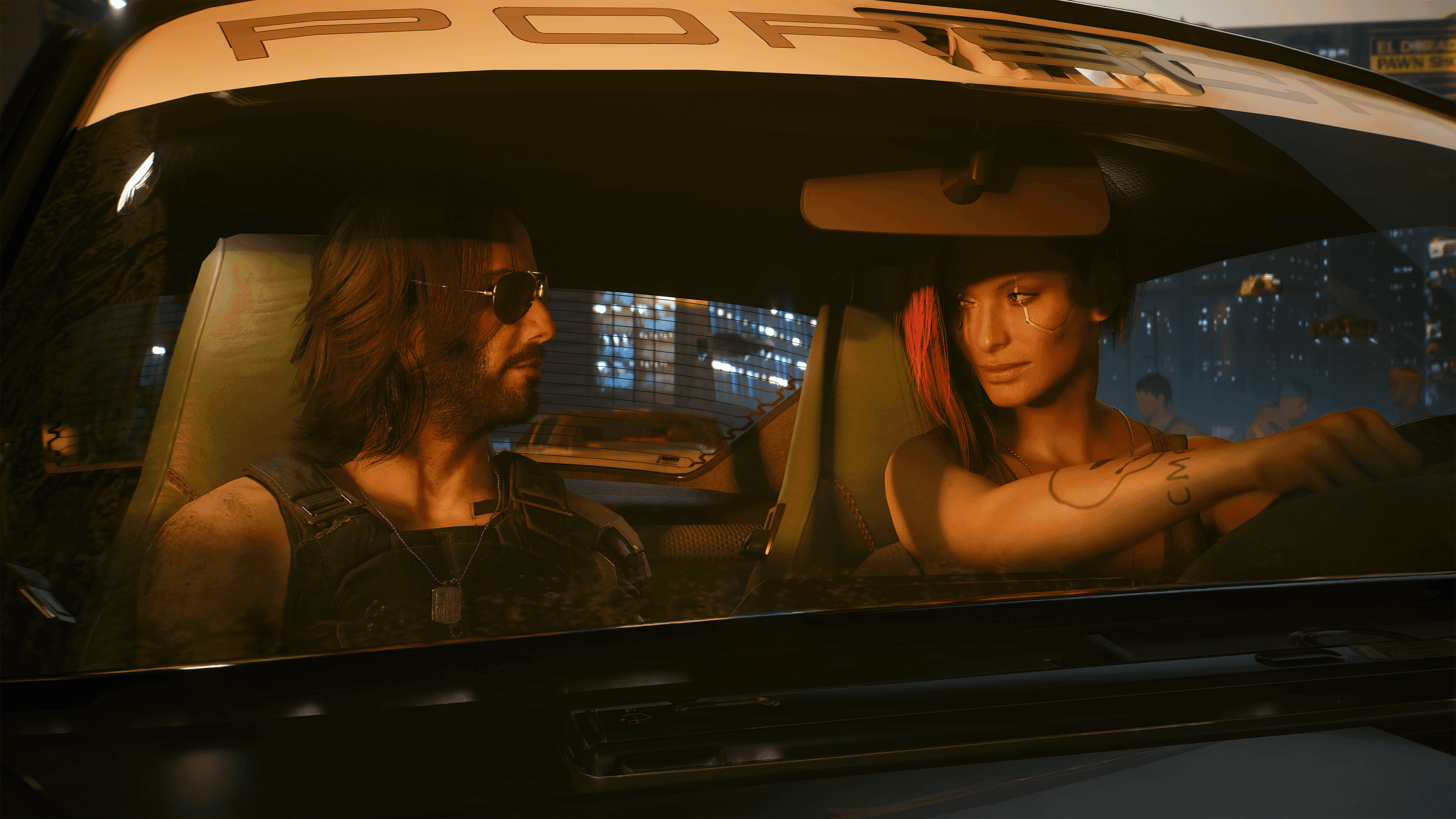 V y Johnny Silverhand recorren Night City en coche. Captura promocional oficial: CD PROJEKT RED.