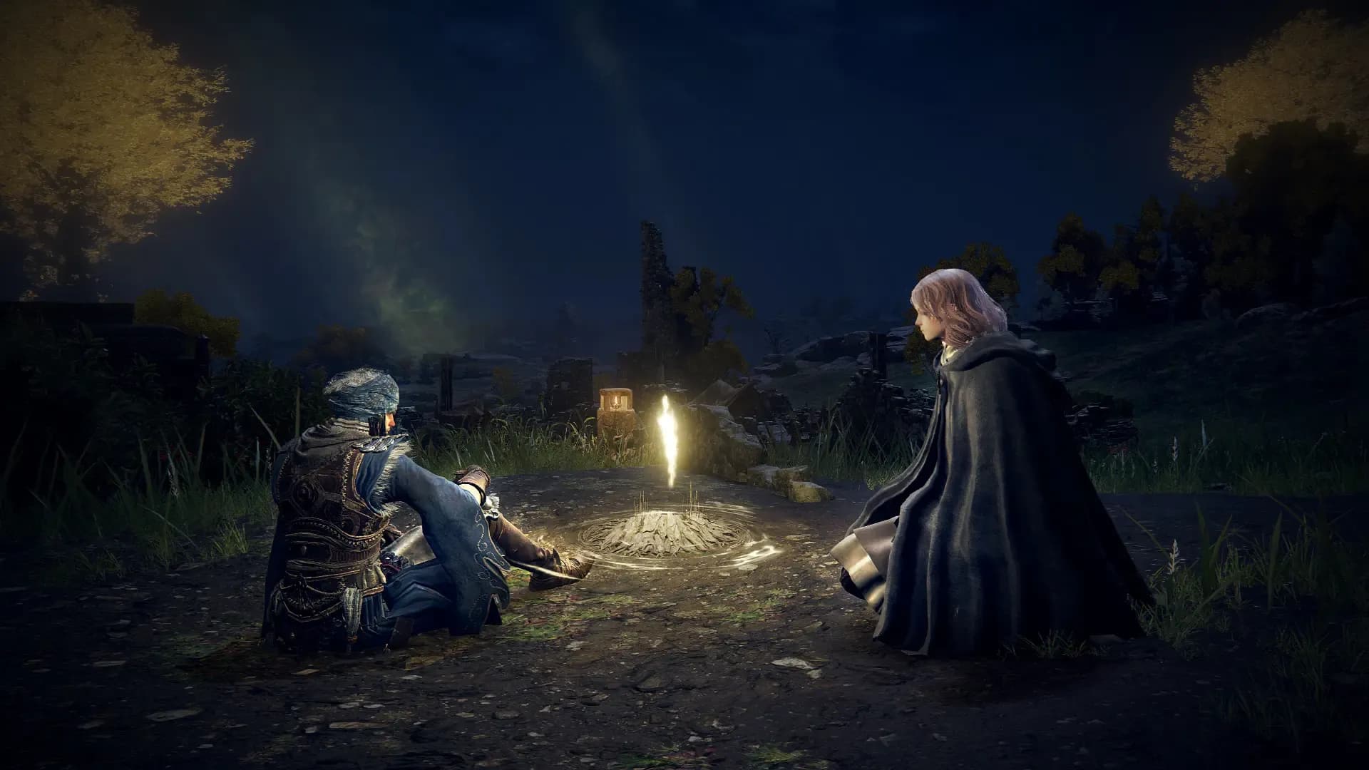 Dos personajes descansan junto a un Lugar de Gracia bajo el cielo nocturno. Captura oficial de Elden Ring: Tarnished Edition para Nintendo Switch 2; © Bandai Namco Entertainment y FromSoftware.