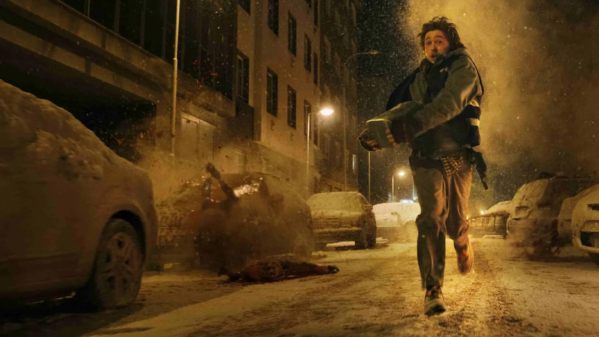 Austin Abrams como Bryan corre por una calle nevada de Raccoon City mientras el caos estalla a su espalda. Foto promocional: cortesía de Sony Pictures; © 2026 CTMG, Inc.